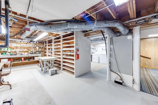 unfinished below grade area featuring washer and dryer and a workshop area