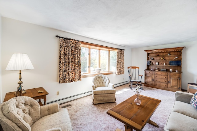 living area with a baseboard heating unit, a baseboard radiator, carpet floors, and baseboards