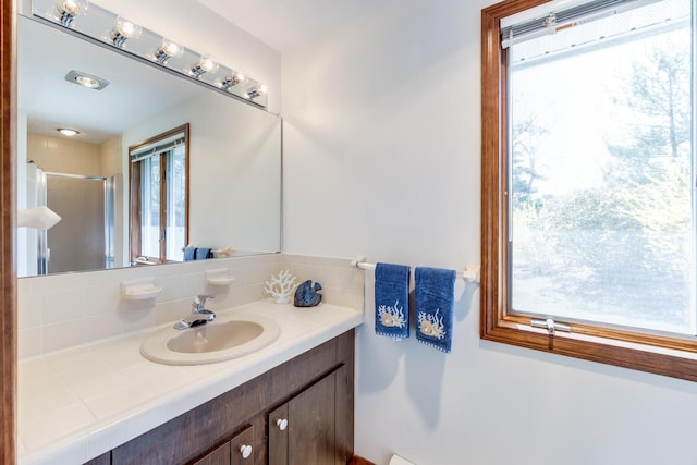 full bath with a shower stall and vanity