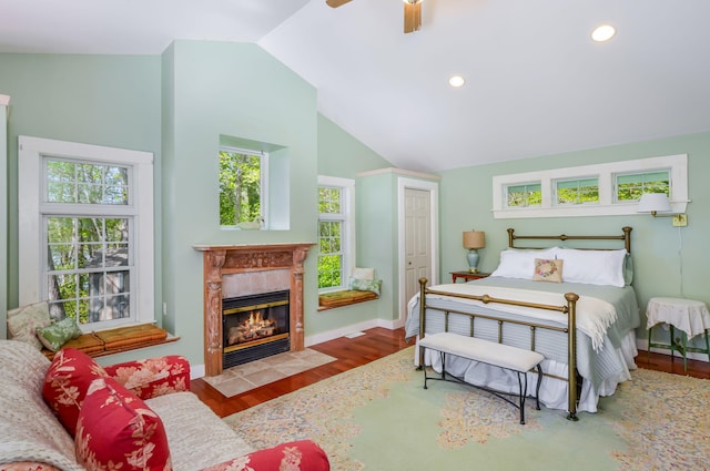 61 Bay Rd, North Falmouth, MA 02556 - bedroom featuring wood finished floors, a tiled fireplace, a ceiling fan, recessed lighting, and baseboards