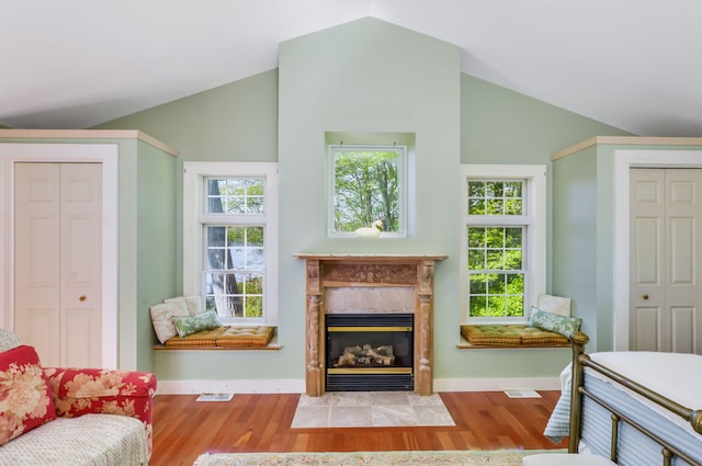 61 Bay Rd, North Falmouth, MA 02556 - living room with vaulted ceiling, a high end fireplace, wood finished floors, baseboards, and healthy amount of natural light