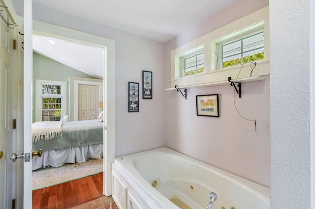 61 Bay Rd, North Falmouth, MA 02556 - ensuite bathroom featuring a jetted tub and lofted ceiling