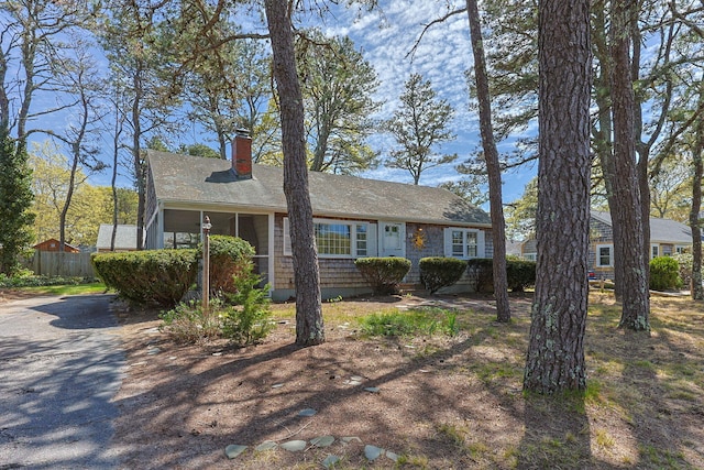 view of front of house with a chimney and fence