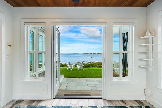 doorway featuring wood ceiling, a water view, and hardwood / wood-style floors