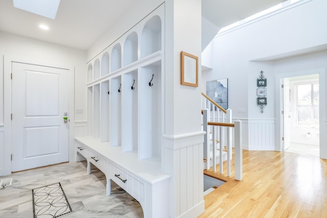 mudroom featuring light wood-type flooring and a skylight