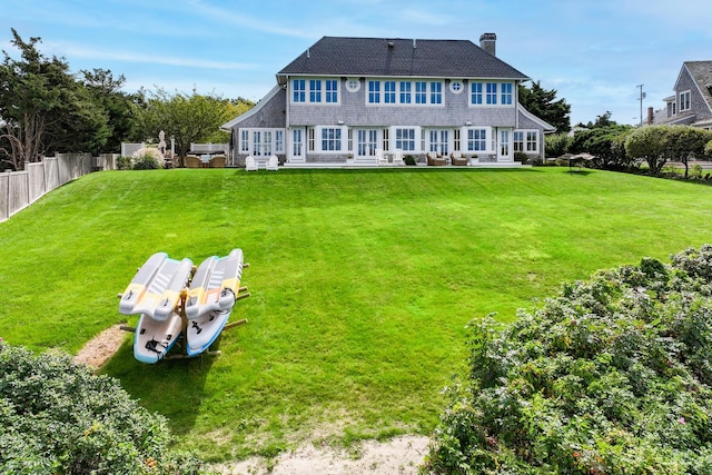 back of house featuring a yard