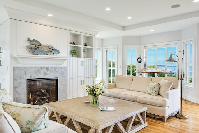 living room featuring wood-type flooring and a fireplace