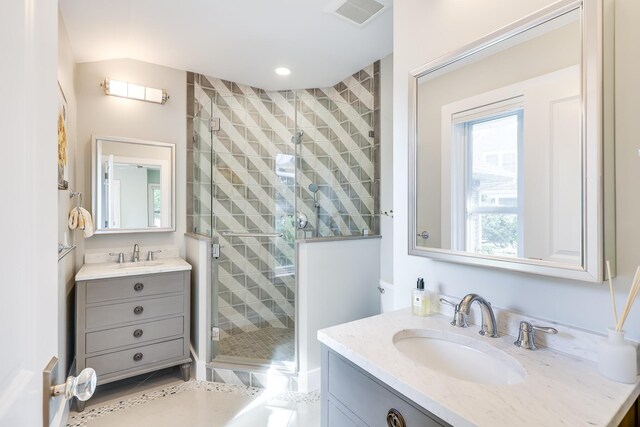 bathroom featuring walk in shower, tile patterned floors, and vanity