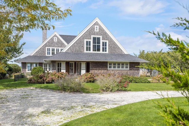 country-style home with a front lawn