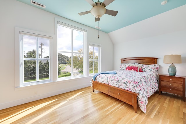 bedroom with ceiling fan, hardwood / wood-style floors, and lofted ceiling