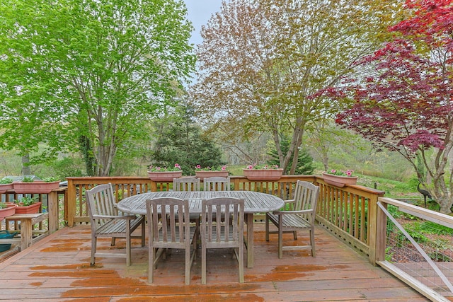 wooden terrace featuring outdoor dining space
