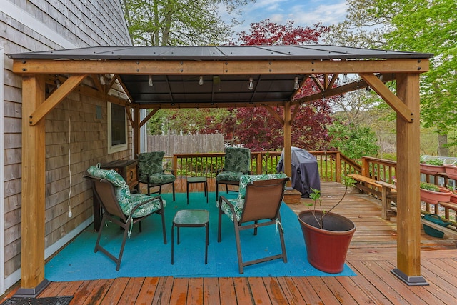 wooden terrace featuring area for grilling, a gazebo, and an outdoor hangout area