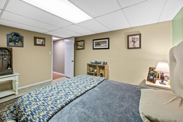 carpeted bedroom with a drop ceiling