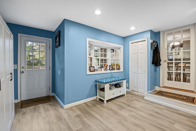 doorway to outside featuring light wood-style flooring, baseboards, and recessed lighting