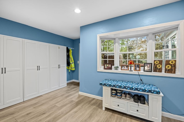 bar area with light wood-style flooring, baseboards, and recessed lighting
