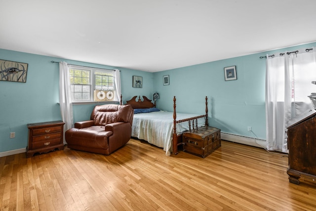 bedroom featuring a baseboard radiator and light wood-type flooring
