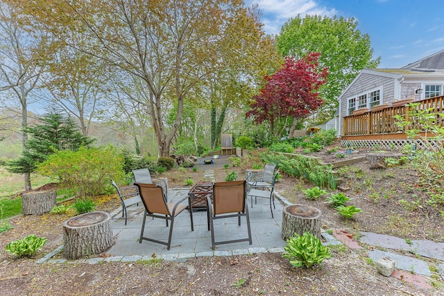 view of patio featuring a wooden deck and a fire pit