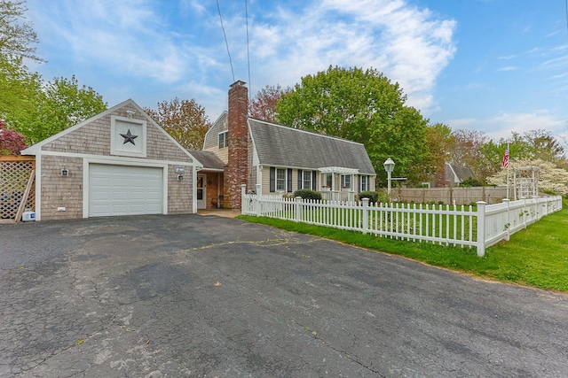 dutch colonial featuring a chimney, asphalt driveway, an attached garage, and roof with shingles