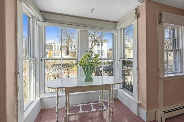 561 Commercial St, Provincetown, MA 02657 - sunroom with hardwood / wood-style floors and a baseboard heating unit