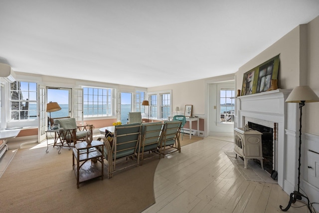 561 Commercial St, Provincetown, MA 02657 - interior space featuring a wall unit AC, light wood finished floors, and a fireplace