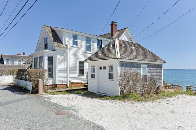 561 Commercial St, Provincetown, MA 02657 - rear view of house with a water view and a chimney