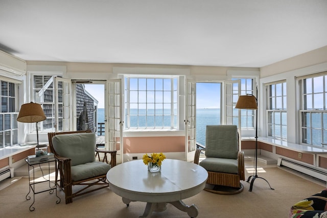 561 Commercial St, Provincetown, MA 02657 - sunroom with a wall unit AC, carpet flooring, a baseboard heating unit, and a water view