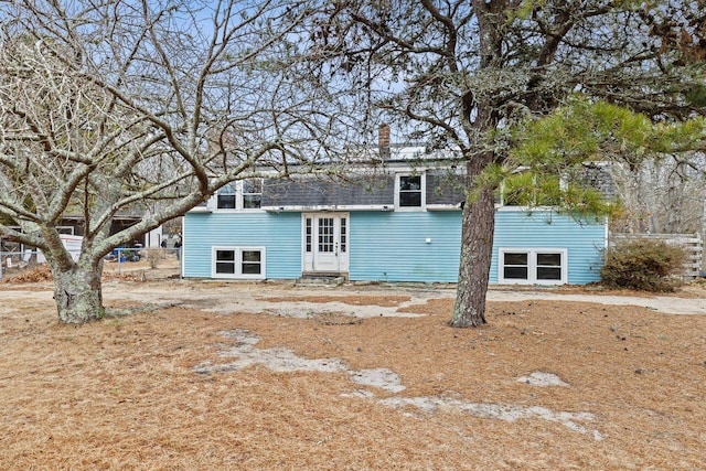 view of front of house with entry steps and a chimney