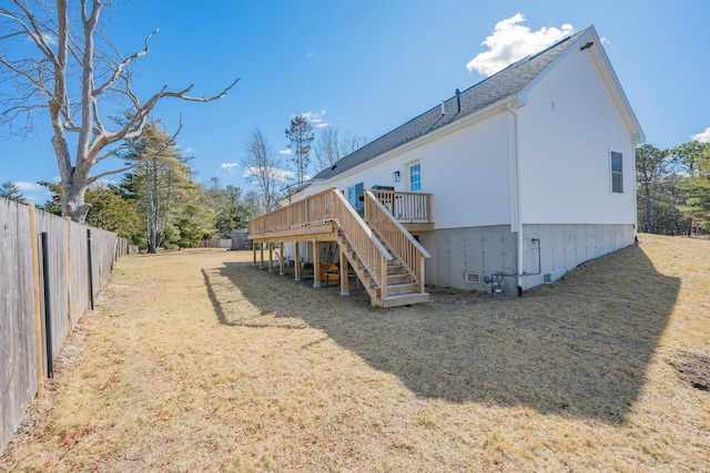 back of property with fence, a wooden deck, stairs, a lawn, and crawl space