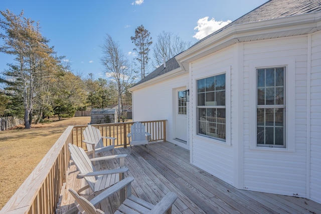 wooden deck with a lawn