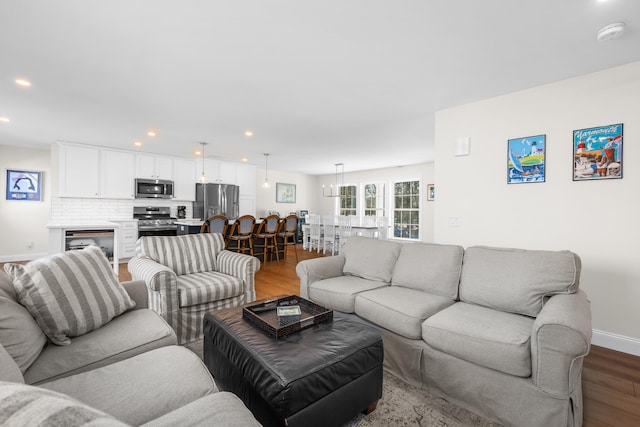 living area with dark wood finished floors, recessed lighting, and baseboards