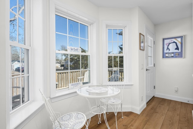 interior space featuring baseboards and wood finished floors