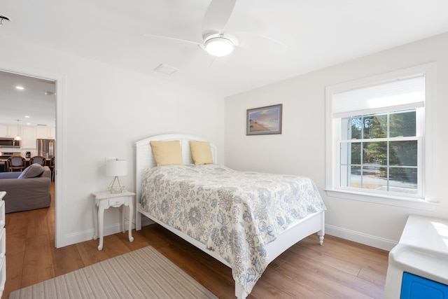 bedroom with a ceiling fan, recessed lighting, wood finished floors, and baseboards