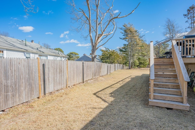 view of yard featuring stairway and a fenced backyard