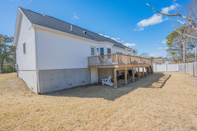 rear view of property with roof with shingles, a wooden deck, a yard, crawl space, and fence private yard