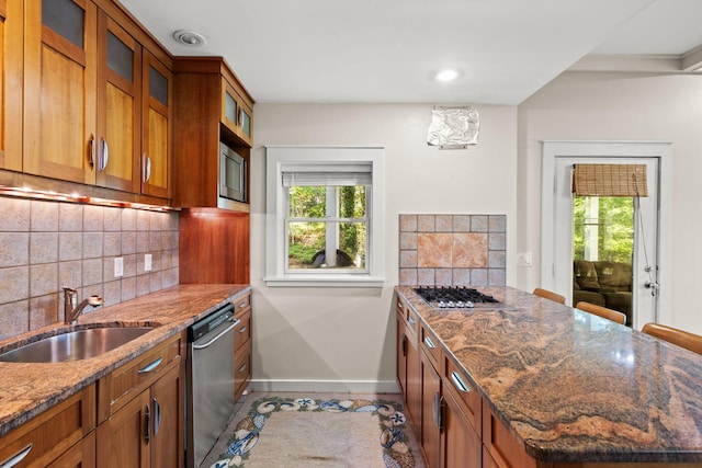 152 Algonquin Ave, Mashpee, MA 02649 - kitchen featuring appliances with stainless steel finishes, brown cabinetry, plenty of natural light, tasteful backsplash, and recessed lighting