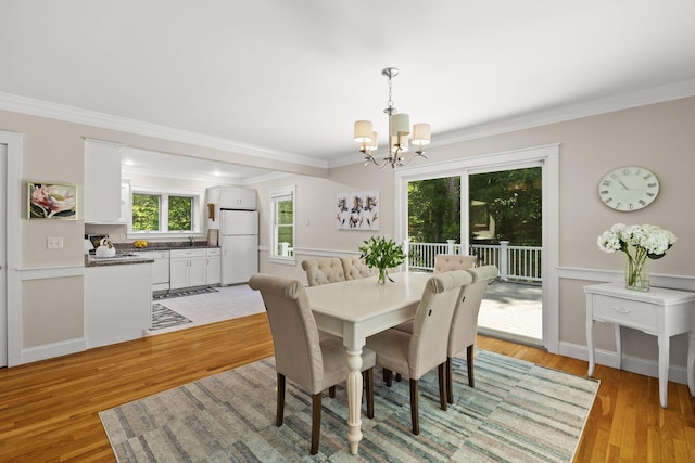 152 Algonquin Ave, Mashpee, MA 02649 - dining space with a chandelier, ornamental molding, and light wood-style flooring
