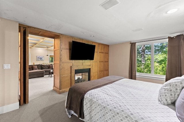 152 Algonquin Ave, Mashpee, MA 02649 - bedroom with light carpet, a multi sided fireplace, and recessed lighting