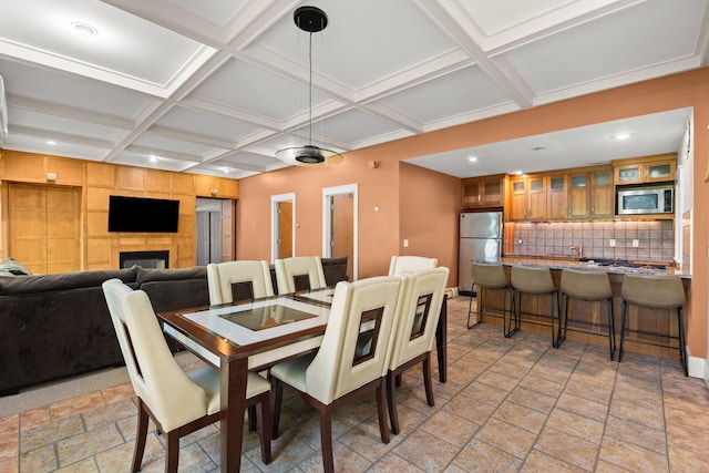 152 Algonquin Ave, Mashpee, MA 02649 - dining space featuring coffered ceiling, stone tile flooring, recessed lighting, beamed ceiling, and a fireplace