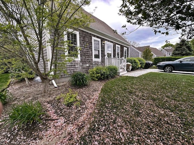 121 Camp St Unit 108, West Yarmouth, MA 02673 - view of home's exterior featuring a lawn and a shingled roof