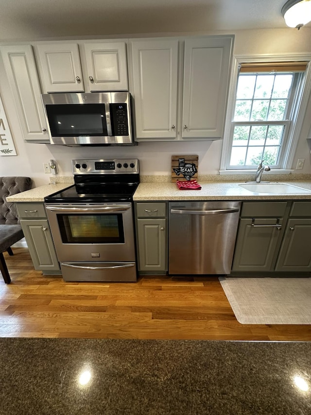 121 Camp St Unit 108, West Yarmouth, MA 02673 - kitchen featuring appliances with stainless steel finishes, gray cabinets, and a sink