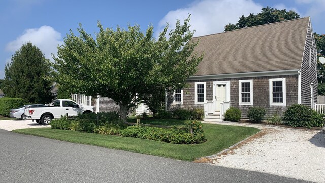 121 Camp St Unit 108, West Yarmouth, MA 02673 - view of front of property featuring a shingled roof and a front lawn
