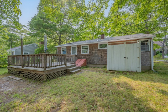 64 Uncle Percys Rd, Mashpee, MA 02649 - back of property with a chimney, a lawn, and a wooden deck