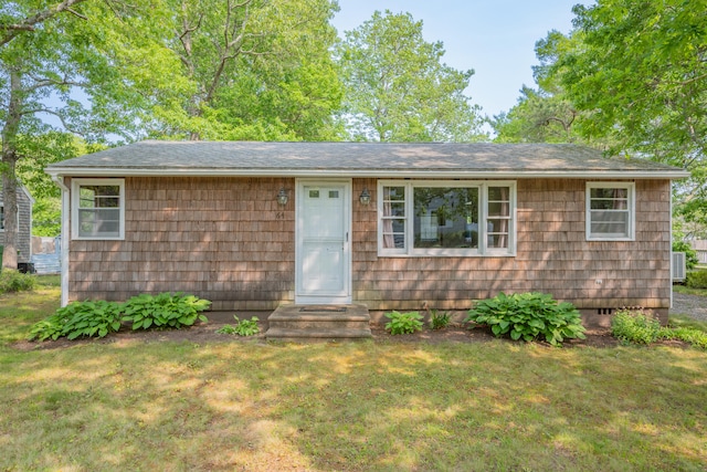 64 Uncle Percys Rd, Mashpee, MA 02649 - view of front facade featuring a front lawn, cooling unit, a shingled roof, and crawl space