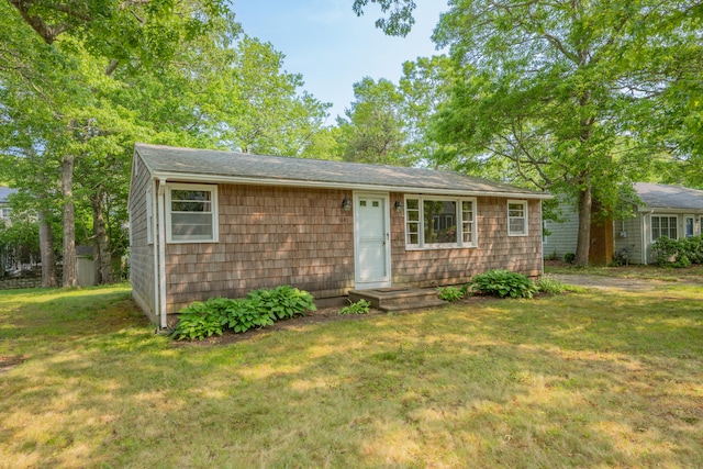 64 Uncle Percys Rd, Mashpee, MA 02649 - view of front of home with a front yard and roof with shingles