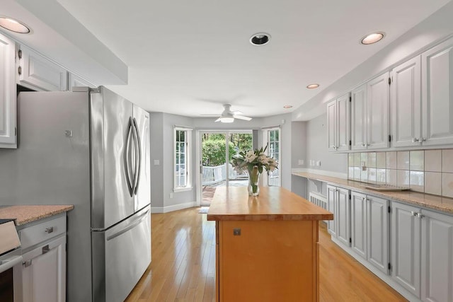 34 Marla Ln, Hatchville, MA 02536 - kitchen with wooden counters, a kitchen island, light wood-style flooring, tasteful backsplash, and ceiling fan