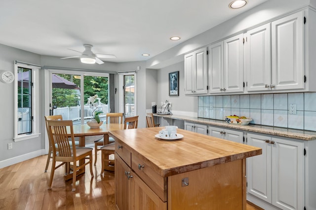34 Marla Ln, Hatchville, MA 02536 - kitchen featuring butcher block countertops, light wood-style flooring, a ceiling fan, decorative backsplash, and white cabinets