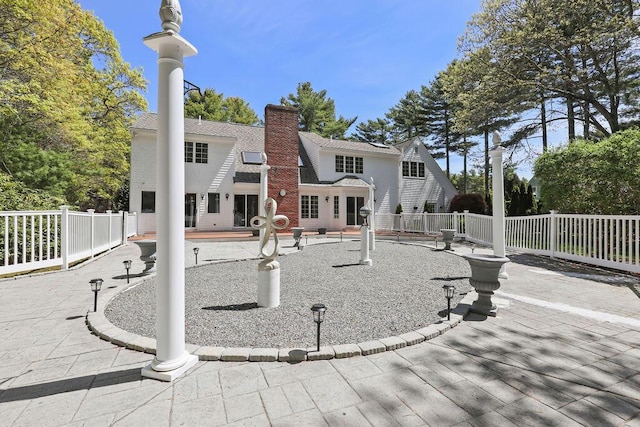 34 Marla Ln, Hatchville, MA 02536 - back of property with fence, a chimney, and a patio