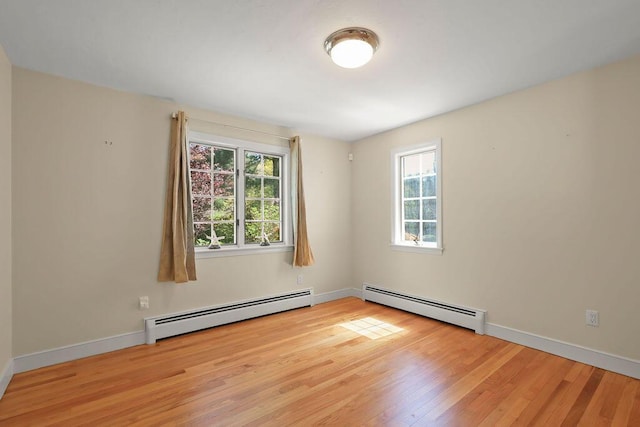 34 Marla Ln, Hatchville, MA 02536 - empty room featuring a baseboard radiator, healthy amount of natural light, and light wood-type flooring