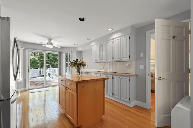 34 Marla Ln, Hatchville, MA 02536 - kitchen with freestanding refrigerator, wood counters, ceiling fan, light wood-style floors, and tasteful backsplash