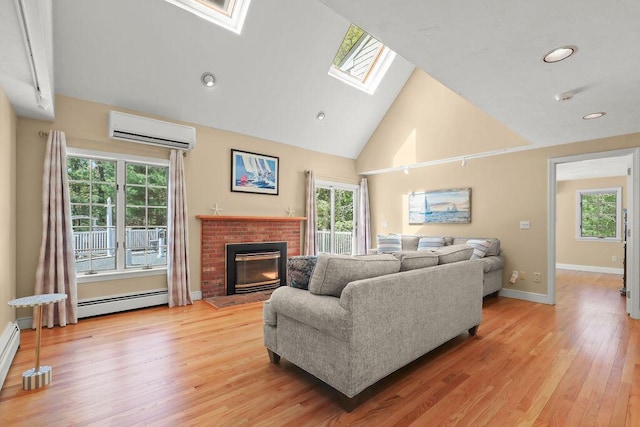 34 Marla Ln, Hatchville, MA 02536 - living room with a wall mounted AC, a skylight, baseboard heating, high vaulted ceiling, and a fireplace